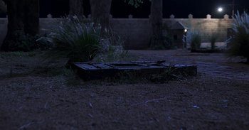 Movie still from “RRR” (2022), directed by S.S. Rajamouli – An old rusted fire hydrant on the side of the road at night; Extreme Wide shot, High angle