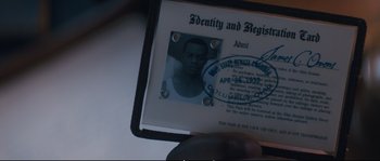 Movie still from “Race” (2016), directed by Stephen Hopkins – An identification card with a picture of a man in it; Extreme Close Up shot, Overhead angle