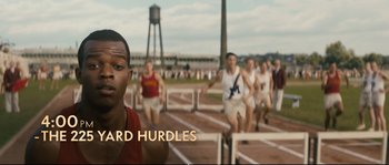 Movie still from “Race” (2016), directed by Stephen Hopkins – A group of men running in a track and field event; Medium shot, High angle