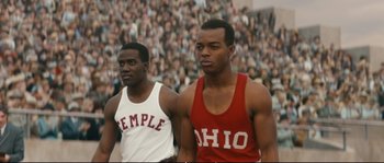 Movie still from “Race” (2016), directed by Stephen Hopkins – A couple of men standing next to each other; Medium shot, High angle