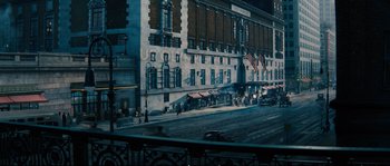 Movie still from “Race” (2016), directed by Stephen Hopkins – An image of a street scene with cars driving down the road; Extreme Wide shot, High angle