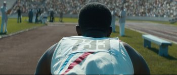 Movie still from “Race” (2016), directed by Stephen Hopkins – The back end of a race car driver; Close Up shot, Over the shoulder angle