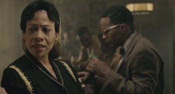 Movie still from “Ray” (2004), directed by Taylor Hackford – A woman and a man are looking at their cell phones; Close Up shot, Over the shoulder angle