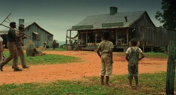 Movie still from “Ray” (2004), directed by Taylor Hackford – Two children standing in front of a house; Wide shot, Low angle