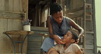 Movie still from “Ray” (2004), directed by Taylor Hackford – A young boy being shaved by an older woman; Close Up shot, Low angle