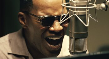 Movie still from “Ray” (2004), directed by Taylor Hackford – A person singing into a microphone; Close Up shot, Low angle