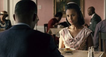 Movie still from “Ray” (2004), directed by Taylor Hackford – A man and a woman sitting at a dinner table; Medium shot, Over the shoulder angle