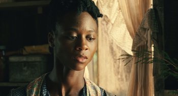 Movie still from “Ray” (2004), directed by Taylor Hackford – A young woman with short black hair is looking off to her left; Close Up shot, Over the shoulder angle