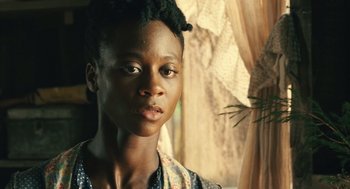 Movie still from “Ray” (2004), directed by Taylor Hackford – A young woman with short black hair is standing in front of a window; Close Up shot, Over the shoulder angle
