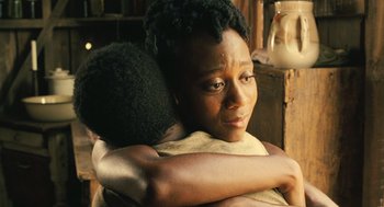 Movie still from “Ray” (2004), directed by Taylor Hackford – A woman is hugging another woman in a room; Close Up shot, Over the shoulder angle