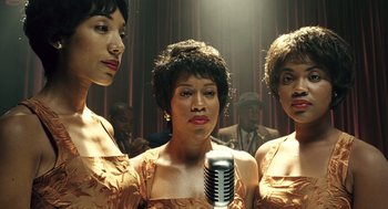 Movie still from “Ray” (2004), directed by Taylor Hackford – A group of women standing next to each other in front of microphones; Close Up shot, Low angle