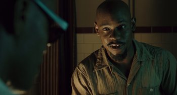 Movie still from “Ray” (2004), directed by Taylor Hackford – A man with a beard is staring at the camera; Close Up shot, Over the shoulder angle