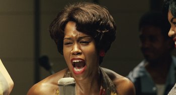 Movie still from “Ray” (2004), directed by Taylor Hackford – A woman singing into a microphone in front of a crowd; Close Up shot, Low angle