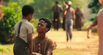 Movie still from “Ray” (2004), directed by Taylor Hackford – A woman and a boy are standing in a field; Medium shot, Over the shoulder angle