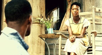 Movie still from “Ray” (2004), directed by Taylor Hackford – A man and a woman sitting in front of each other on a porch; Medium shot, Over the shoulder angle