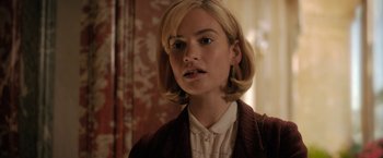 Movie still from “Rebecca” (2020), directed by Ben Wheatley – A person with short blonde hair; Close Up shot, Over the shoulder angle