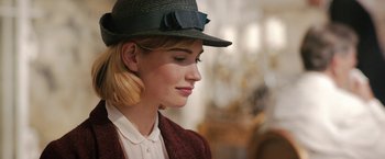 Movie still from “Rebecca” (2020), directed by Ben Wheatley – A woman wearing a hat and a sweater; Close Up shot, Over the shoulder angle