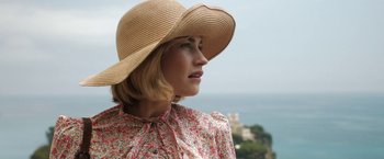 Movie still from “Rebecca” (2020), directed by Ben Wheatley – A woman wearing a straw hat looking off into the distance; Close Up shot, High angle