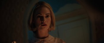 Movie still from “Rebecca” (2020), directed by Ben Wheatley – A woman with short blonde hair is looking at the camera; Close Up shot, Low angle