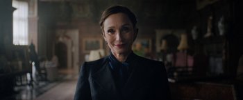 Movie still from “Rebecca” (2020), directed by Ben Wheatley – A person wearing a suit; Close Up shot, Over the shoulder angle