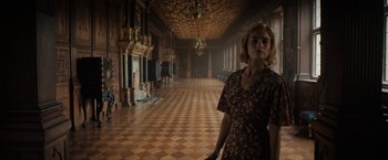Movie still from “Rebecca” (2020), directed by Ben Wheatley – A woman standing in the middle of an empty room; Wide shot, Low angle
