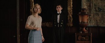 Movie still from “Rebecca” (2020), directed by Ben Wheatley – A man and a woman standing next to each other in front of a mirror; Medium shot, Low angle