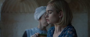 Movie still from “Rebecca” (2020), directed by Ben Wheatley – A woman holding a cucumber in front of another woman; Close Up shot, Over the shoulder angle