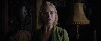 Movie still from “Rebecca” (2020), directed by Ben Wheatley – A person wearing a green shirt; Close Up shot, Over the shoulder angle