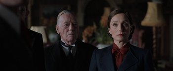 Movie still from “Rebecca” (2020), directed by Ben Wheatley – A man and a woman standing next to each other; Medium shot, Over the shoulder angle