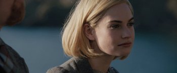 Movie still from “Rebecca” (2020), directed by Ben Wheatley – A person with blonde hair; Close Up shot, Over the shoulder angle