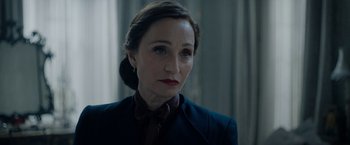 Movie still from “Rebecca” (2020), directed by Ben Wheatley – A person wearing a suit and tie; Close Up shot, Over the shoulder angle