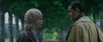 Movie still from “Rebecca” (2020), directed by Ben Wheatley – A man and a woman standing next to each other on a path; Close Up shot, Over the shoulder angle