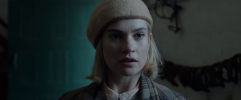 Movie still from “Rebecca” (2020), directed by Ben Wheatley – A person wearing a hat; Close Up shot, Over the shoulder angle