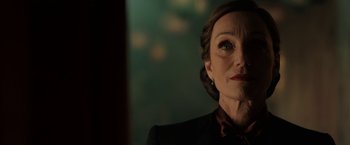 Movie still from “Rebecca” (2020), directed by Ben Wheatley – A person wearing a suit and tie; Close Up shot, Low angle