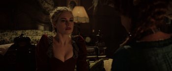 Movie still from “Rebecca” (2020), directed by Ben Wheatley – A beautiful woman in a red dress sitting next to a man; Close Up shot, Over the shoulder angle