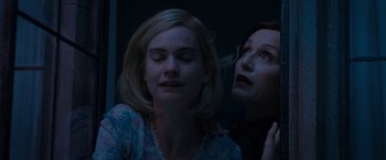 Movie still from “Rebecca” (2020), directed by Ben Wheatley – Two women looking at each other in a dark room; Close Up shot, Low angle