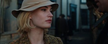 Movie still from “Rebecca” (2020), directed by Ben Wheatley – A person wearing a hat; Close Up shot, Over the shoulder angle