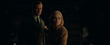 Movie still from “Rebecca” (2020), directed by Ben Wheatley – A man and a woman standing next to each other in the dark; Medium shot, Low angle