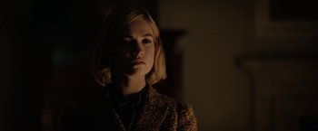 Movie still from “Rebecca” (2020), directed by Ben Wheatley – A woman with blonde hair wearing a brown jacket; Close Up shot, Low angle