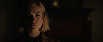 Movie still from “Rebecca” (2020), directed by Ben Wheatley – A person with short blonde hair; Close Up shot, Over the shoulder angle