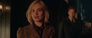 Movie still from “Rebecca” (2020), directed by Ben Wheatley – A person with short blonde hair; Close Up shot, Over the shoulder angle