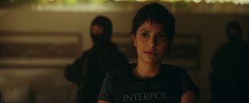 Movie still from “Red Notice” (2021), directed by Rawson Marshall Thurber – A woman in a black shirt and a man in a black mask; Close Up shot, Over the shoulder angle