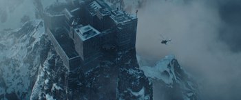 Movie still from “Red Notice” (2021), directed by Rawson Marshall Thurber – An aerial view of a castle in the middle of a snowy mountain; Extreme Wide shot, High angle