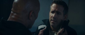 Movie still from “Red Notice” (2021), directed by Rawson Marshall Thurber – A man looking at his reflection in a mirror; Close Up shot, Over the shoulder angle