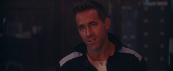 Movie still from “Red Notice” (2021), directed by Rawson Marshall Thurber – A person wearing a black jacket; Close Up shot, Over the shoulder angle