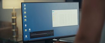Movie still from “Red Notice” (2021), directed by Rawson Marshall Thurber – A computer monitor with a computer on top of it; Extreme Close Up shot, High angle
