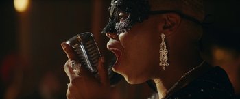 Movie still from “Red Notice” (2021), directed by Rawson Marshall Thurber – A person holding a microphone; Close Up shot, Low angle