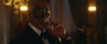 Movie still from “Red Notice” (2021), directed by Rawson Marshall Thurber – A person wearing a mask; Close Up shot, Over the shoulder angle