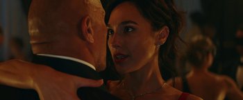 Movie still from “Red Notice” (2021), directed by Rawson Marshall Thurber – A man and a woman in formal wear looking into each others eyes; Close Up shot, Over the shoulder angle