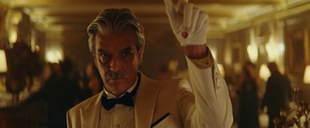 Movie still from “Red Notice” (2021), directed by Rawson Marshall Thurber – A man that is wearing a suit and a bow tie; Close Up shot, Low angle